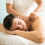 very-relaxed-young-latin-man-getting-deep-tissue-massage-his-back-wellness-spa-clinic-min